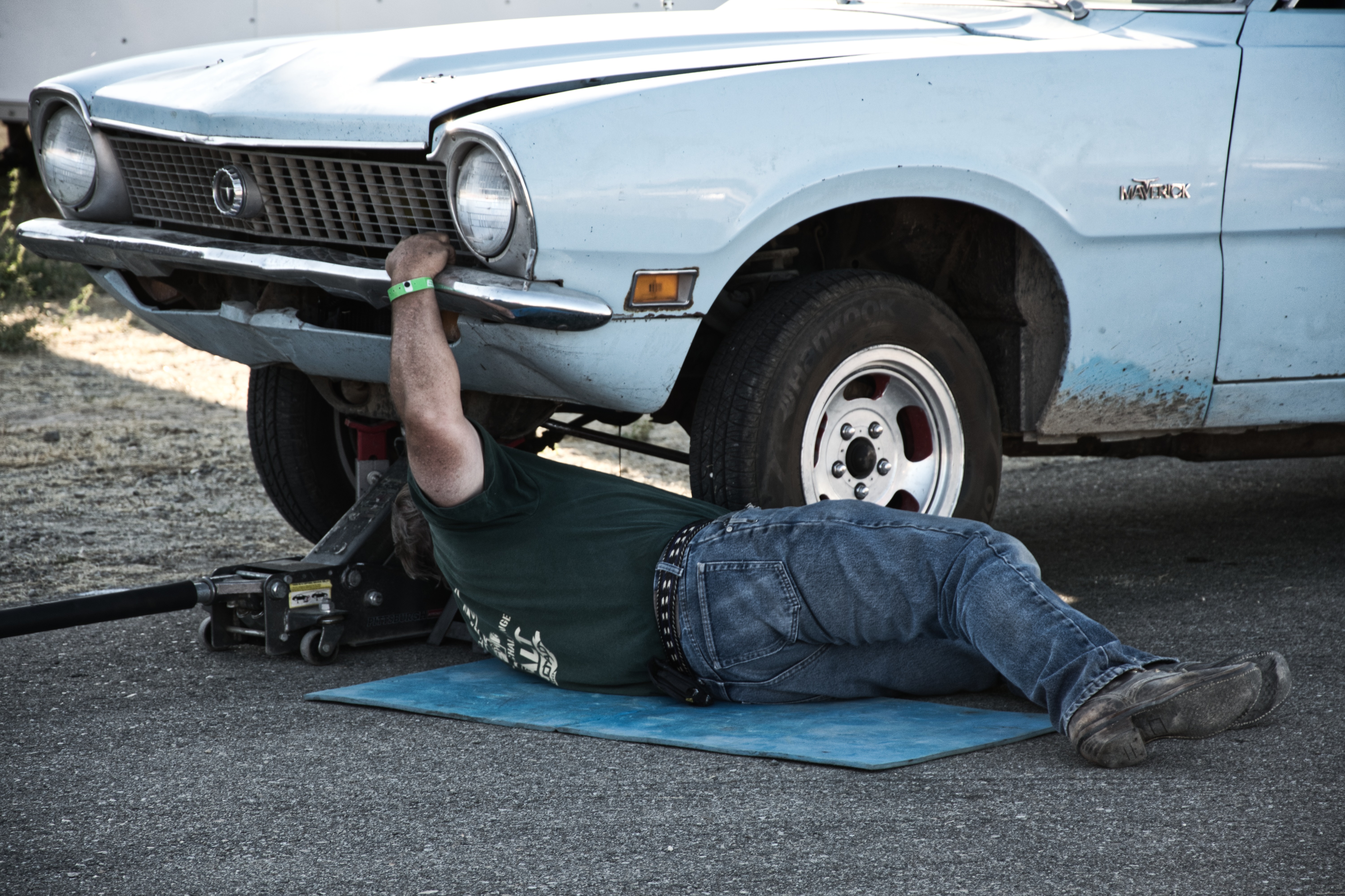 a man fixing a vehicle